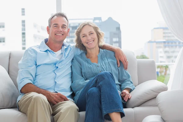 Happy couple relaxing on their couch — Stock Photo, Image