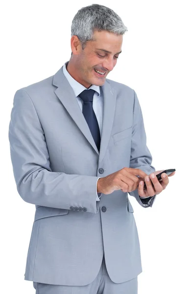 Cheerful businessman sending text message — Stock Photo, Image