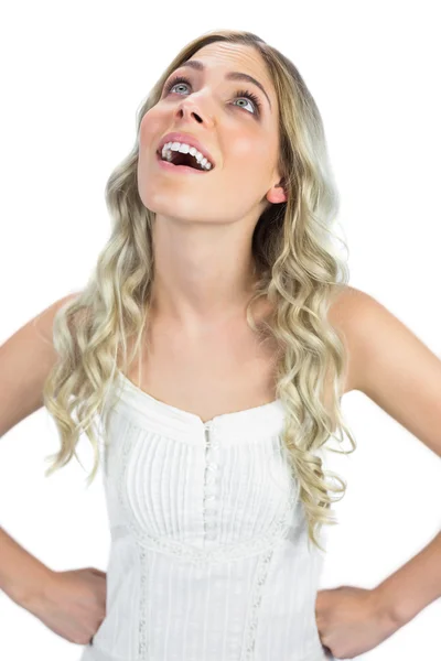 Smiling intrigued sexy blonde looking up — Stock Photo, Image
