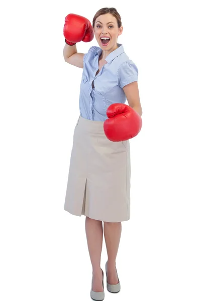 Cheerful businesswoman with red boxing gloves — Stock Photo, Image