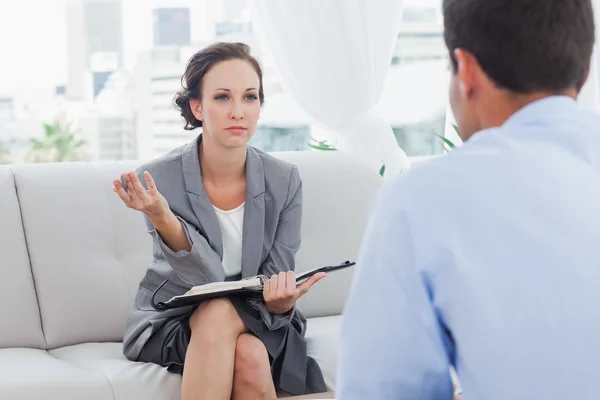 Serious businesswoman talking to her colleague — Stock Photo, Image