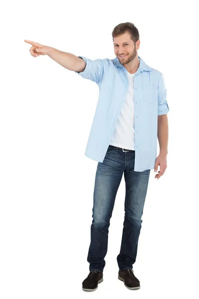 Confident model looking at camera while pointing — Stock Photo, Image