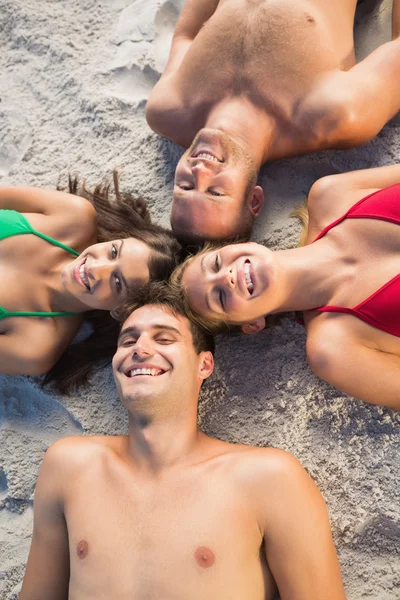 Overhead of smiling friends lying together in a circle — Stock Photo, Image