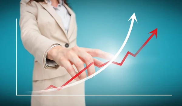 Businesswoman touching futuristic red and white graph with arrow — Stock Photo, Image