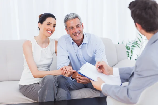 Couple listening to salesman holding contract — Stock Photo, Image