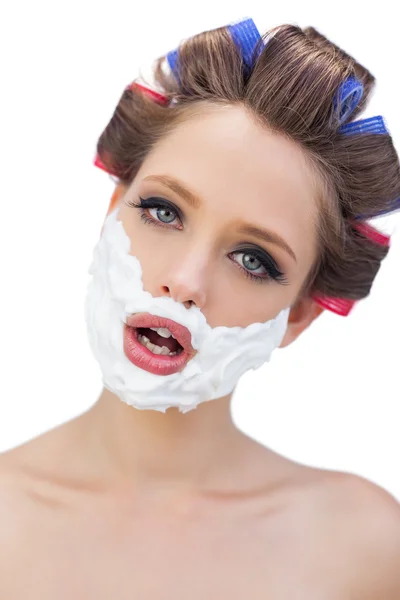 Model in hair curlers with shaving foam in close up — Stock Photo, Image