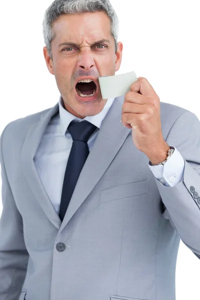 Businessman ripping off duct tape from mouth — Stock Photo, Image