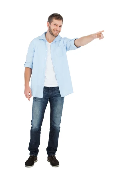 Confident model smiling and looking at camera while pointing — Stock Photo, Image