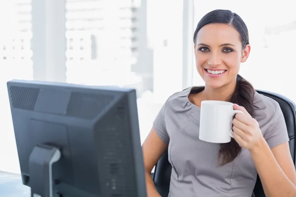 Smiling attractive businesswoman holding mug — Stock Photo, Image