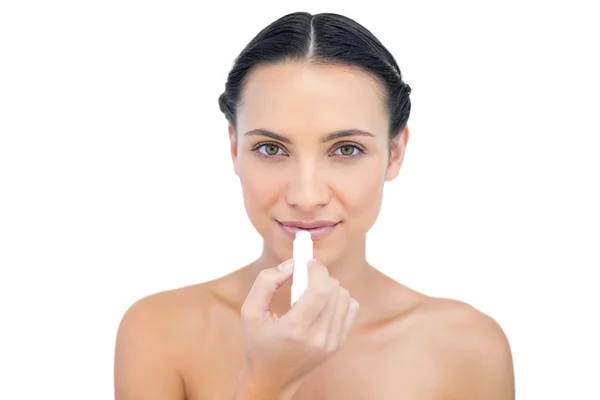 Relaxed natural model applying chap stick — Stock Photo, Image