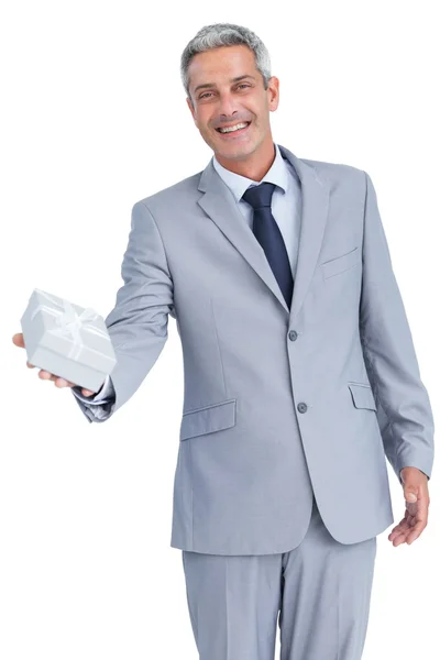 Good looking businessman offering gift — Stock Photo, Image