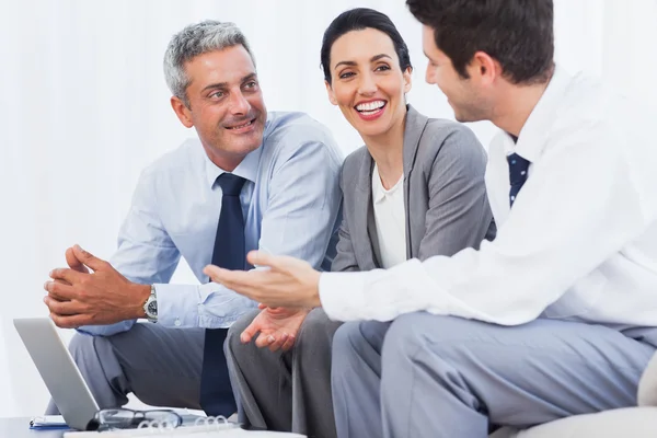 Happy business people working with their laptop on sofa — Stock Photo, Image