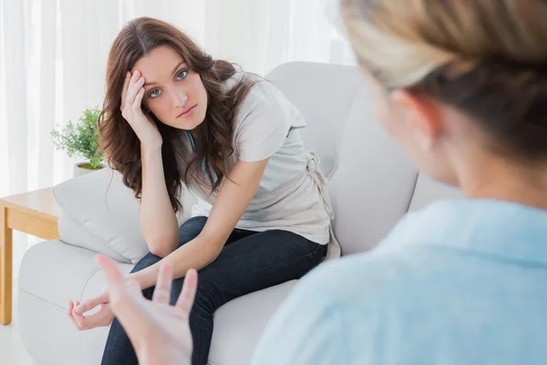 Worried woman sitting and looking at camera during therapy — Stock Photo, Image