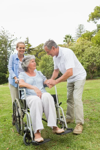 Volwassen vrouw in rolstoel met echtgenoot en dochter — Stockfoto