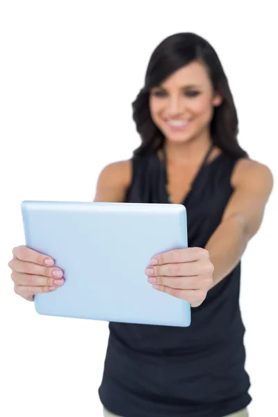 Smiling elegant brown haired model looking at her tablet pc — Stock Photo, Image