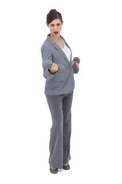 Businesswoman holding dumbbells — Stock Photo, Image