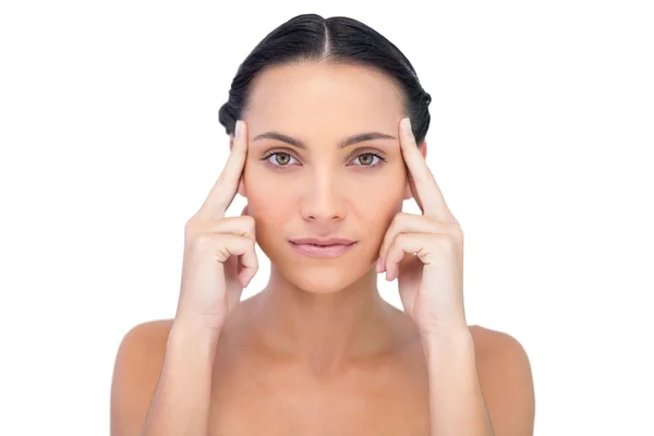 Young model posing while touching her forehead — Stock Photo, Image