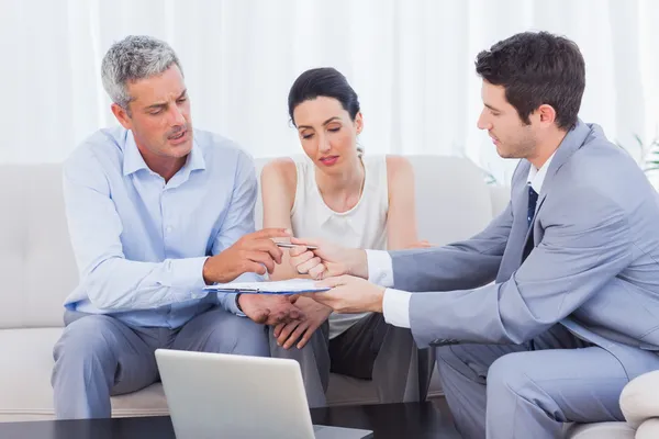 Verkoper contract te geven aan de client en zijn vrouw — Stockfoto