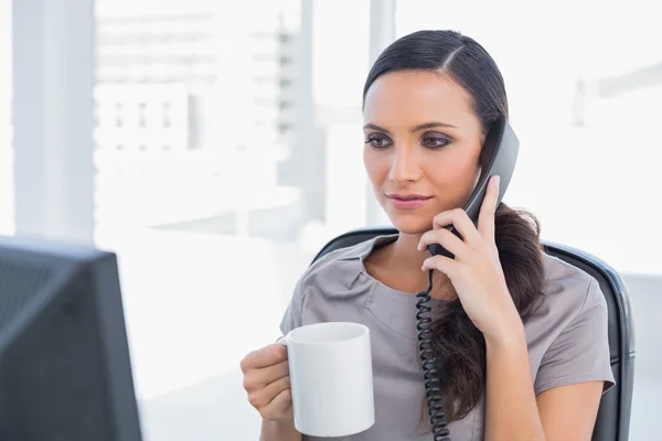 Serious secretary answering phone — Stock Photo, Image