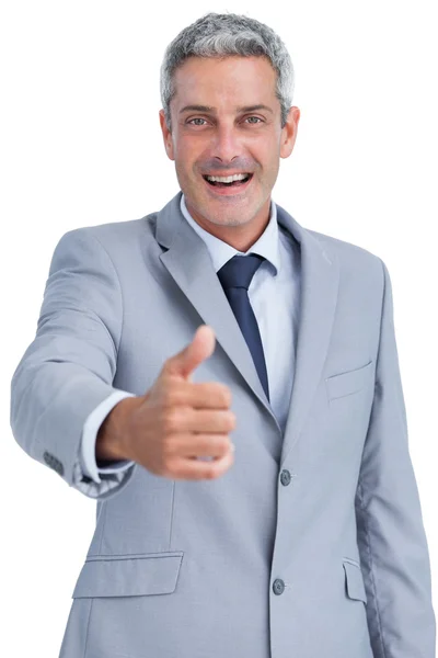 Cheerful businessman looking at camera reaching for handshake — Stock Photo, Image