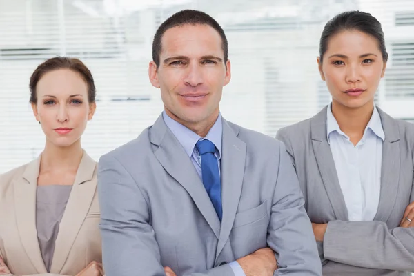 Serious partners posing crossing arms — Stock Photo, Image