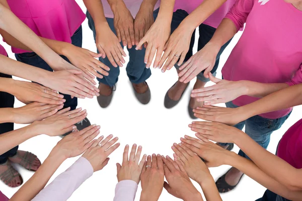 Hands joined in circle wearing pink for breast cancer — Stock Photo, Image