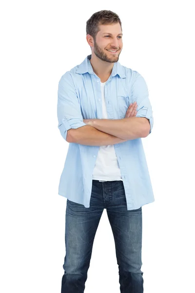 Smiling man crossing arms and looking away — Stock Photo, Image