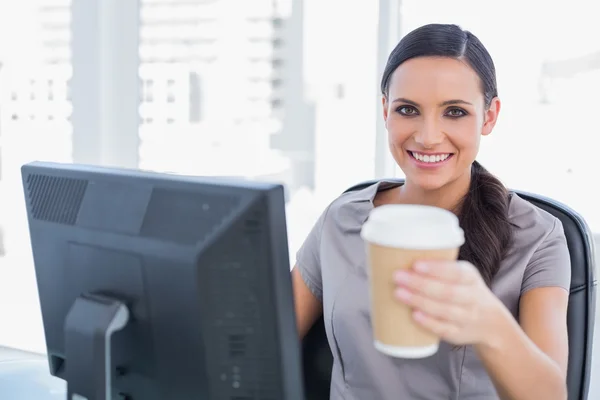 Attractive businesswoman offering coffee — Stock Photo, Image
