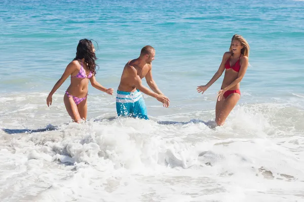 Cheerful friends playing in the sea — Stock Photo, Image