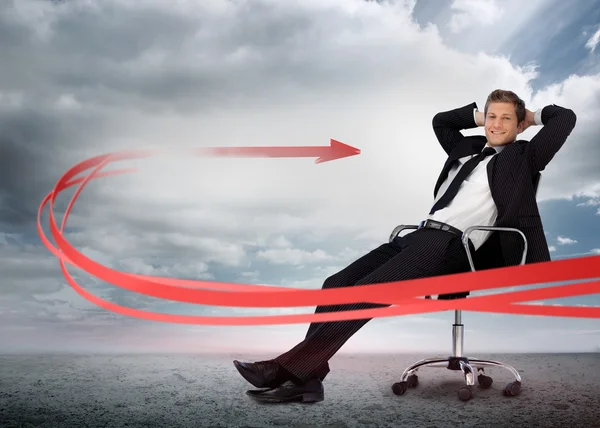 Businessman sitting with red arrow going past him — Stock Photo, Image