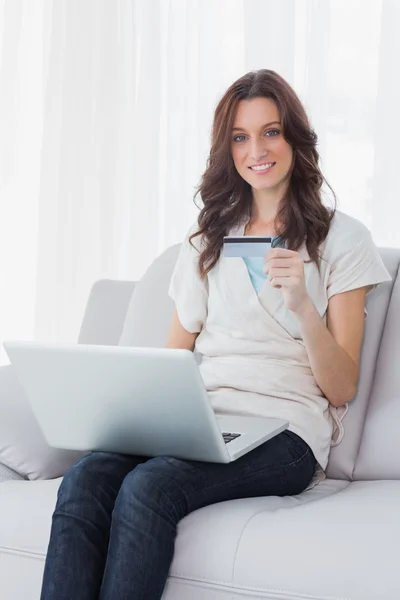 Woman shopping online and smiling at camera — Stock Photo, Image