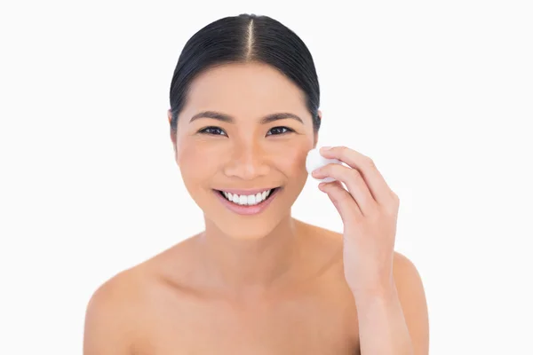 Smiling beautiful model using cotton pad on her face — Stock Photo, Image