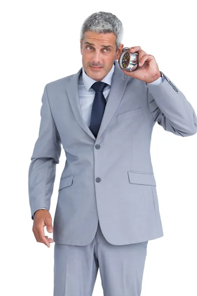 Concerned businessman with alarm clock — Stock Photo, Image