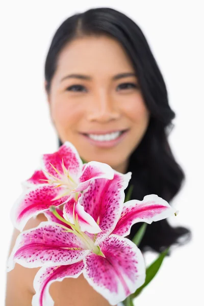 Cheerful natural brown haired model posing with lily — Stock Photo, Image