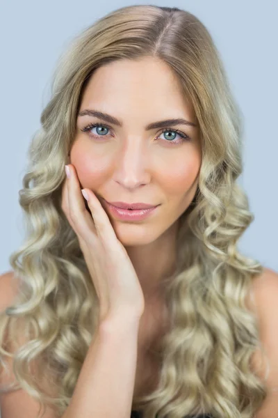 Thoughtful gorgeous blond model posing touching her face — Stock Photo, Image