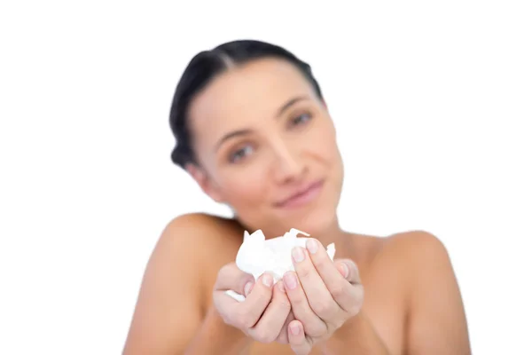 Smiling natural brunette holding tissue — Stock Photo, Image