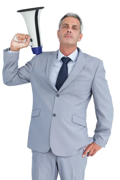 Businessman posing with loudspeaker on his shoulder — Stock Photo, Image