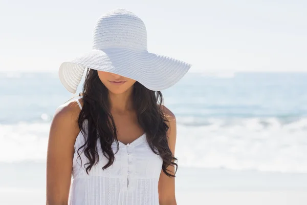 Beautiful brunette in white sunhat looking down — Stock Photo, Image