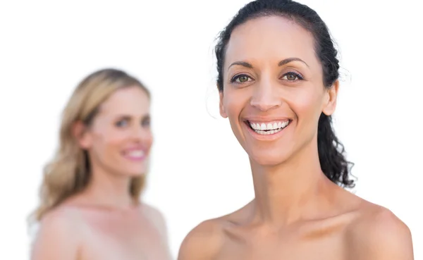 Smiling brunette on foreground with blonde on background — Stock Photo, Image