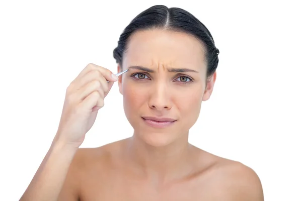 Serious natural model using tweezers — Stock Photo, Image