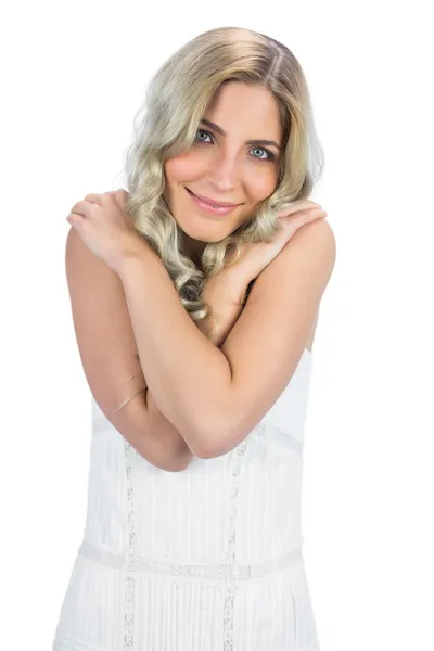 Curly haired blonde hugging herself — Stock Photo, Image