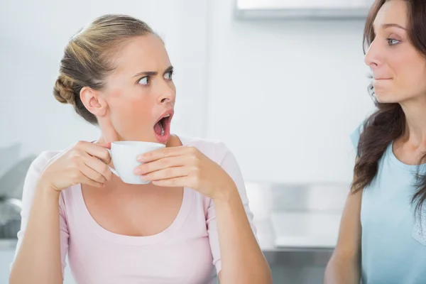 Dazed blonde looking at her friend — Stock Photo, Image