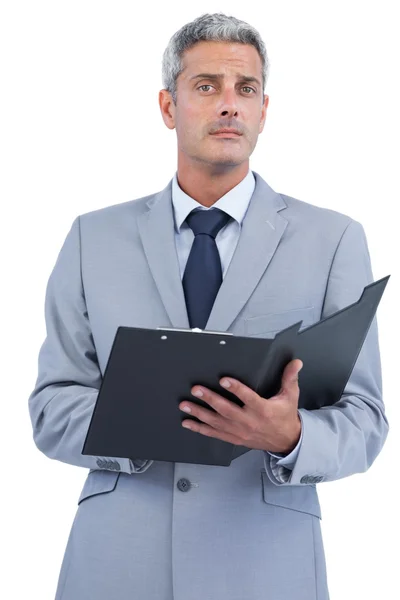 Self assured businessman with clipboard Royalty Free Stock Images