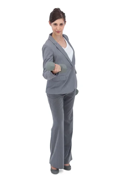 Businesswoman exercising with dumbbells — Stock Photo, Image
