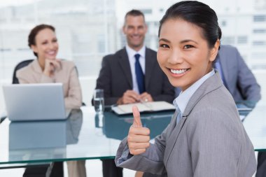 Young applicant giving thumb up after obtaining the job clipart