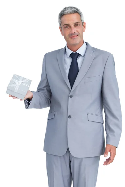 Attractive businessman holding gift — Stock Photo, Image