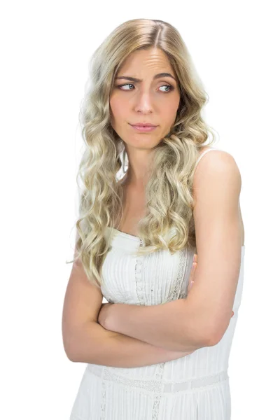 Uninterested model in white dress rising her eyebrow — Stock Photo, Image