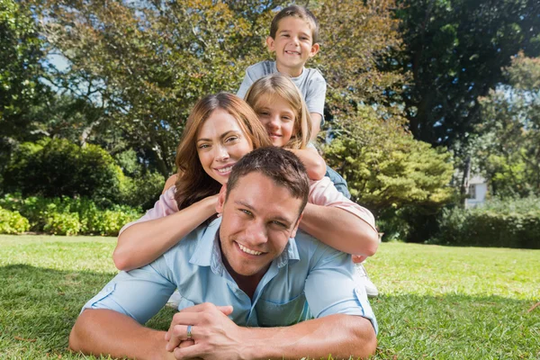 Glückliche Familienmitglieder, die aufeinander liegen — Stockfoto