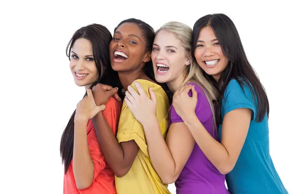 Diverse young women laughing at camera and embracing — Stock Photo, Image
