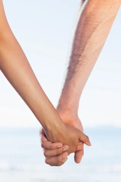 Loving young couple grasping hands — Stock Photo, Image